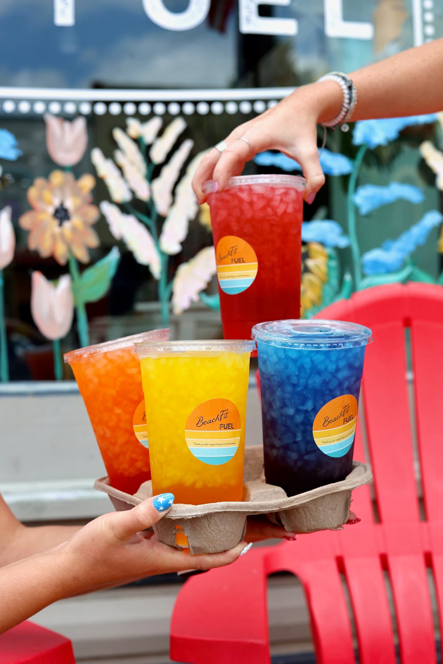 A carrier of colorful BeachFit Fuel drinks