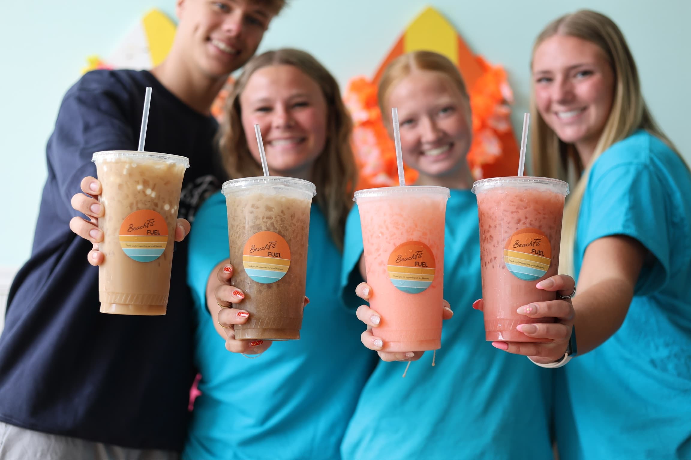 The BeachFit Fuel team holding up drinks